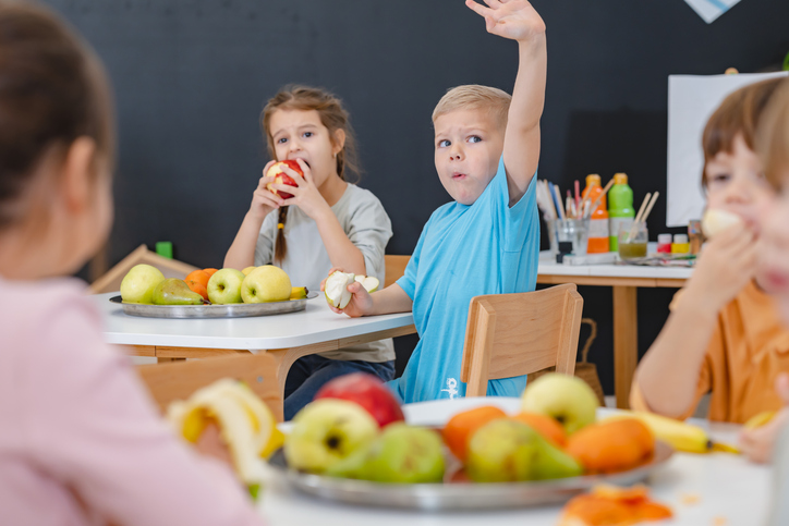 Children eating a fruit snack in a kindergarten